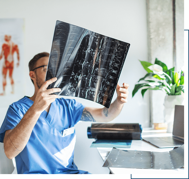 Doctor examining X-ray in medical office.